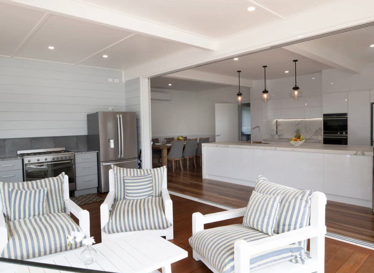 A living room with striped chairs and a table