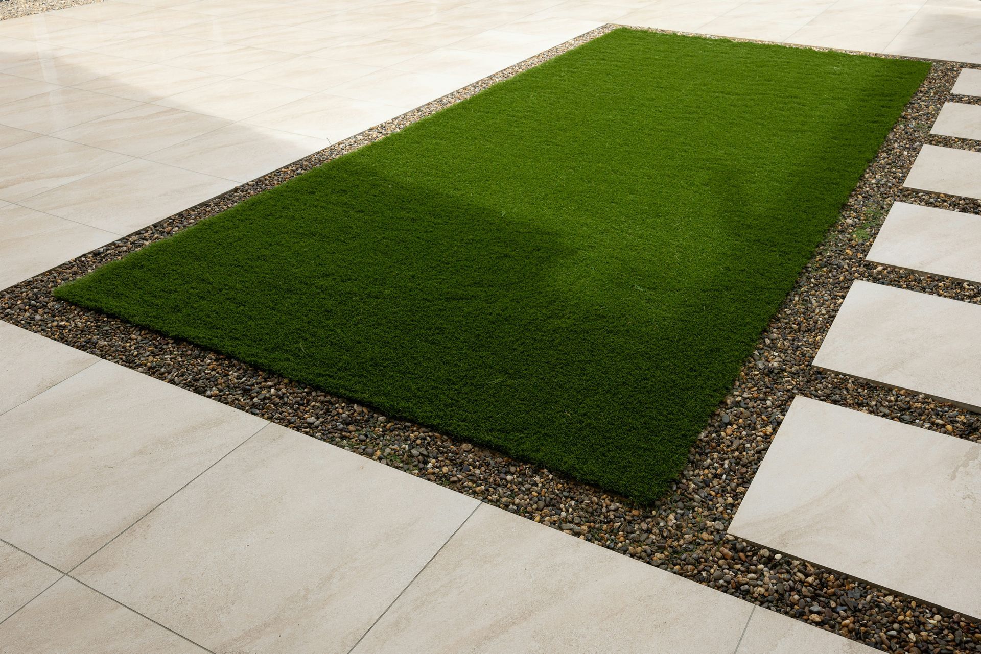Artificial grass integrated with tile to enhance a home backyard 