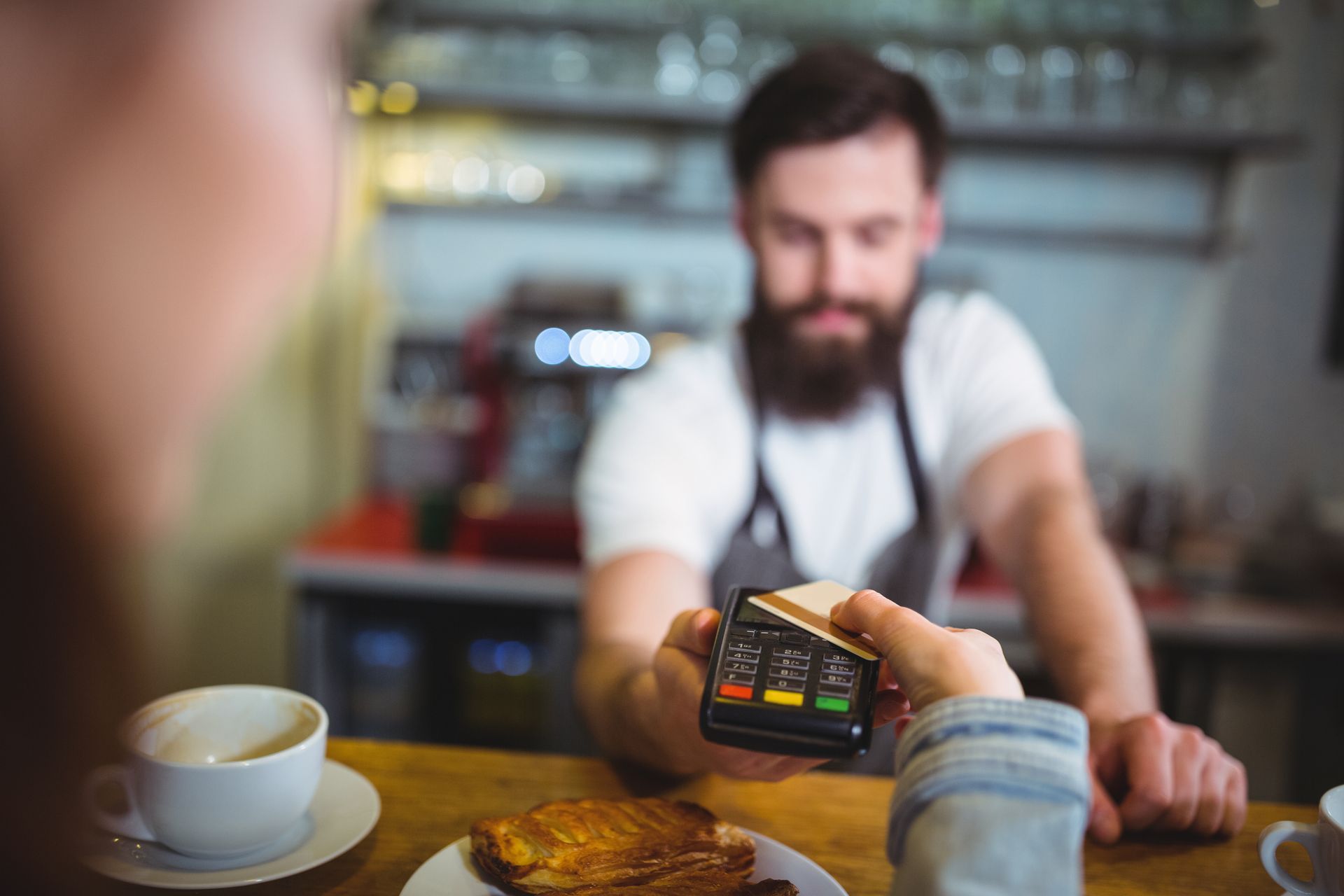 customer making payment through payment terminal counter credit card score manare debt relief