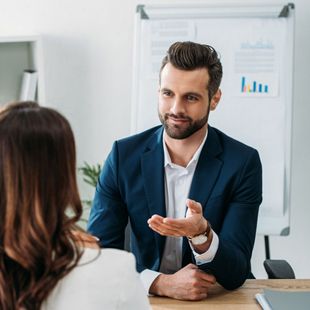 a man negotiating with a women assisting her resolving her debts