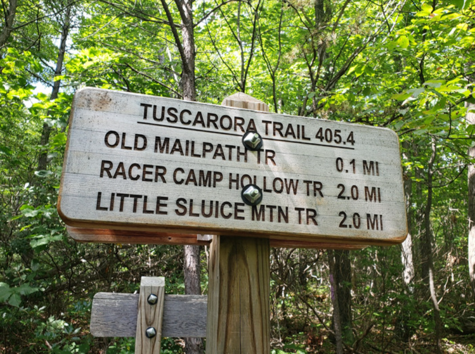 The Tuscarora trail sign, shows three different trails: Old Mailpath trail, Racer Camp Hollow trail, and Little Sluice Mountain Trail.