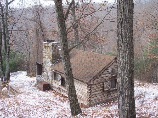 An aerial view of the Doyles River cabin shows a stone chimney and a brick roof.