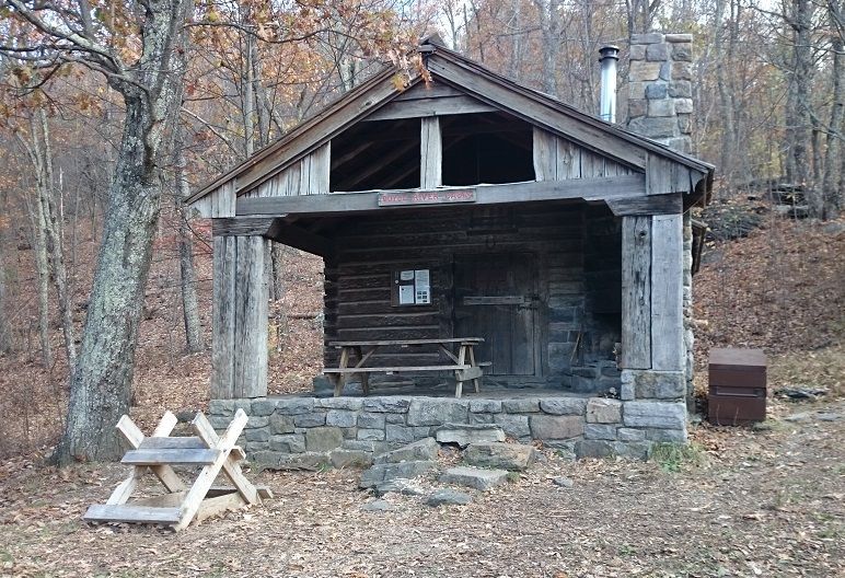 The front of the Doyles River cabin shows a porch with a picnic table.