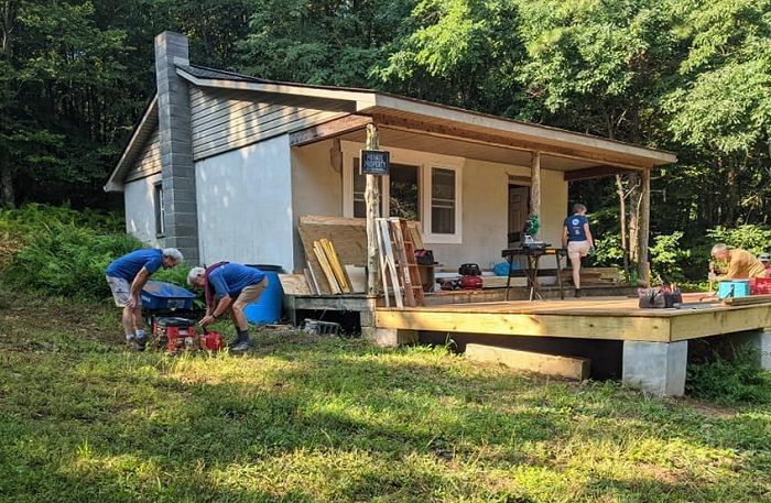 PATC volunteers working together to build a large, wooden front porch for the Jarmans Gap cabin.