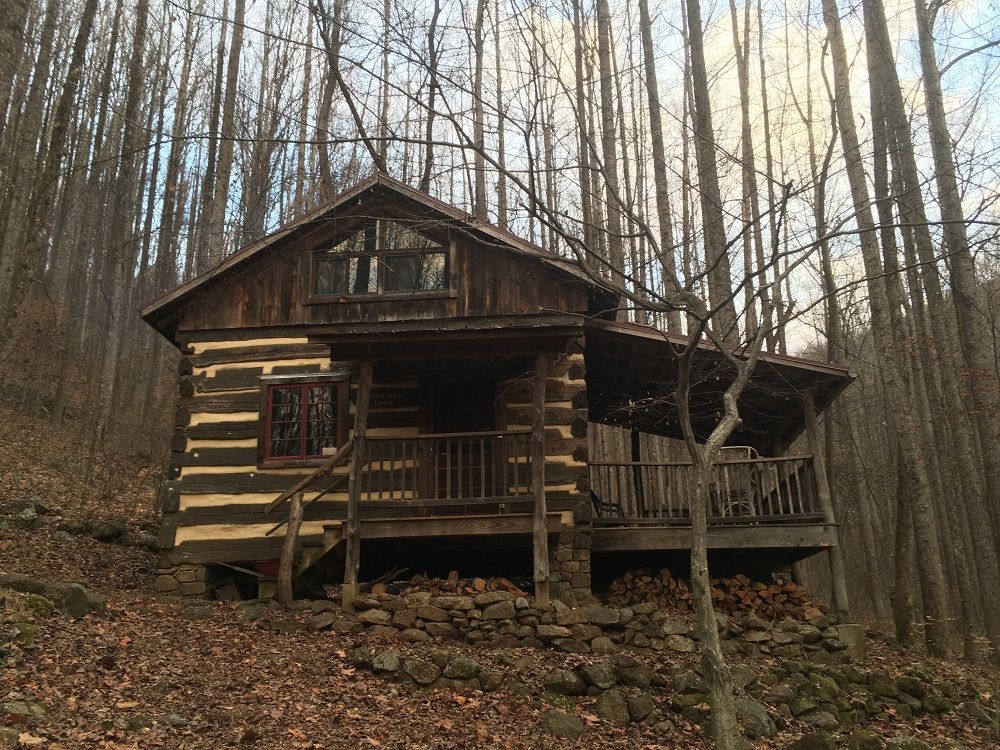 The exterior of Johns Rest cabin shows a small wooden porch.
