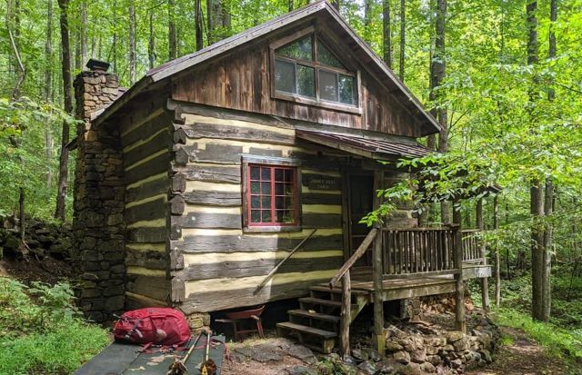 The front view of Johns rest cabin showing a small wooden porch.