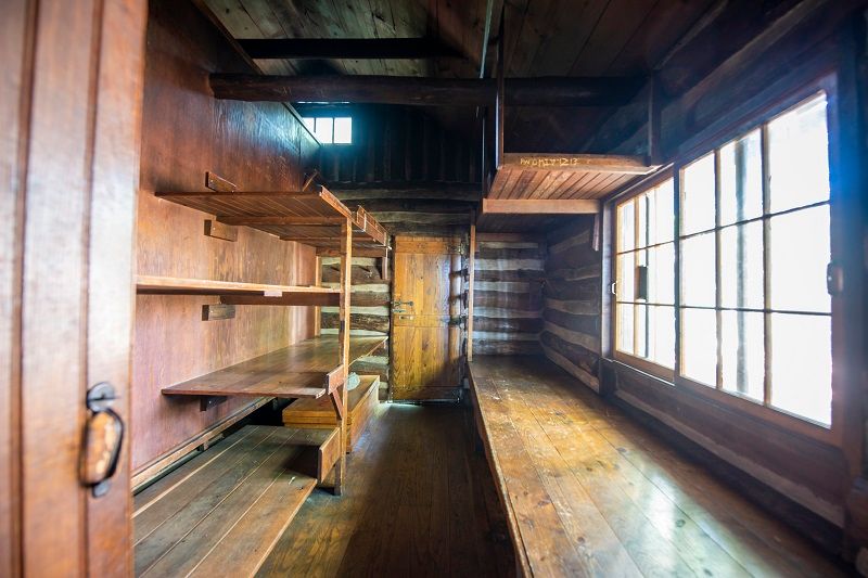 The interior of the Anna-Michener cabin showing varying levels of wooden bunks.