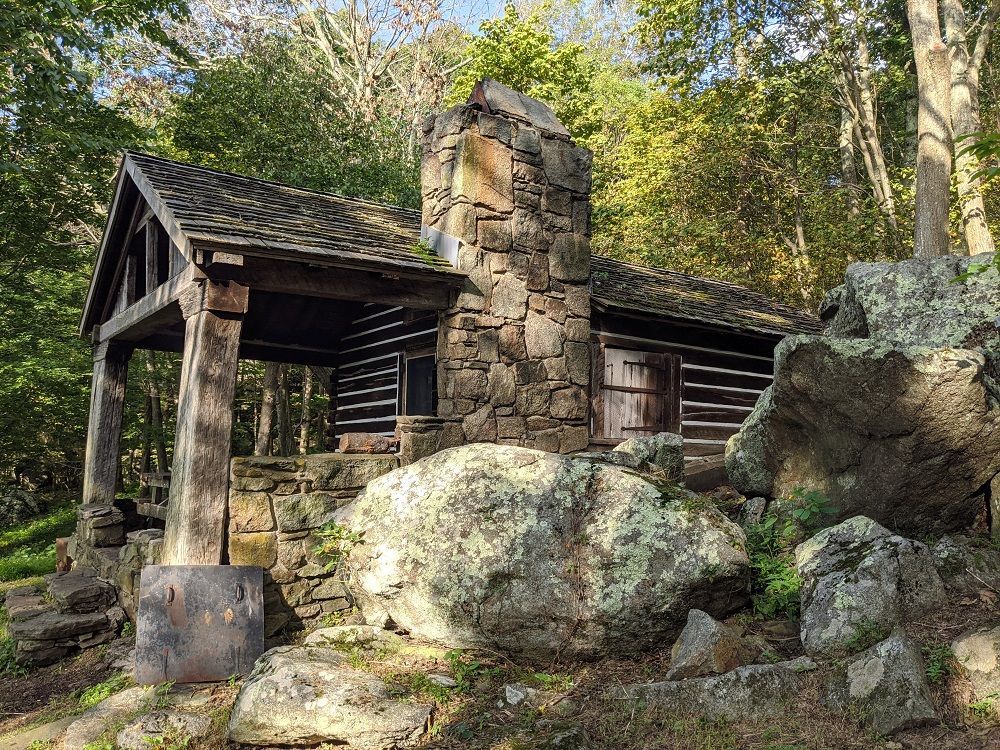 The side view of the Rock Spring cabin, showing rocks and boulders.
