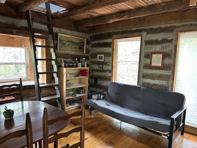 An exterior view of Fort Valley cabin shows a small wooden porch and highlights it's stone walls