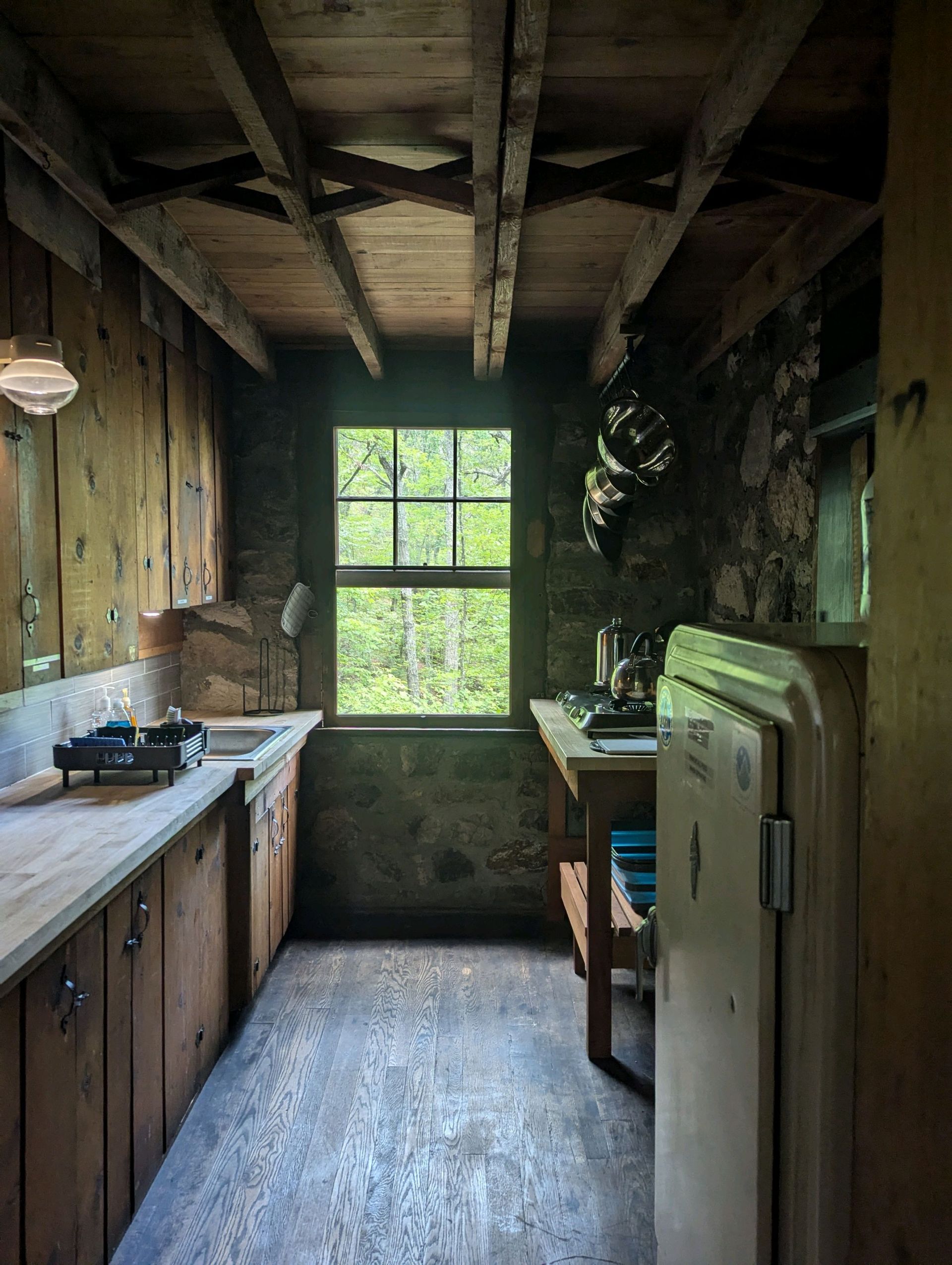 a rustic looking kitchen with wooden cabinets and countertops 