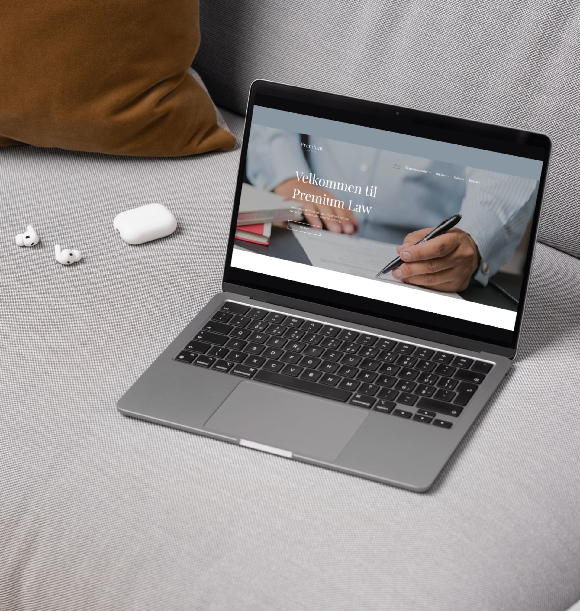 A laptop is open on a couch with a website on the screen