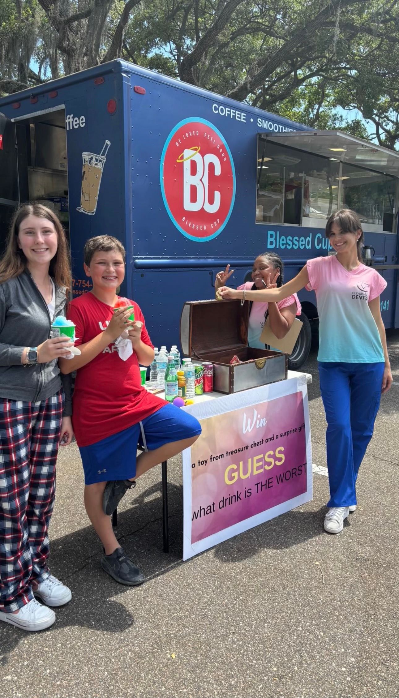 A group of people are standing in front of a food truck.