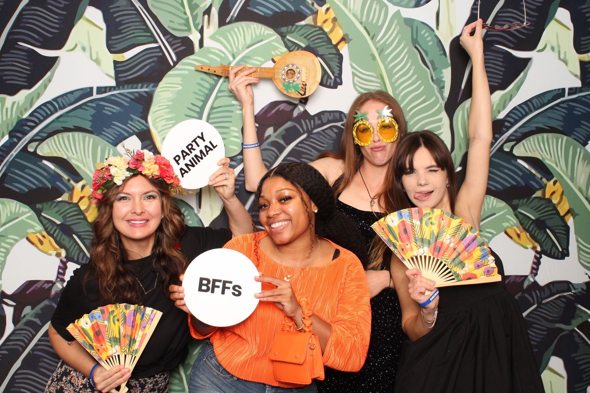 A group of women are posing for a picture in a photo booth.
