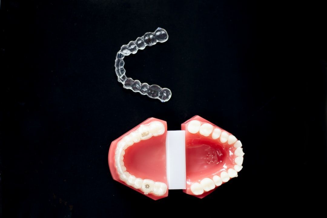 A model of a mouth with a clear brace on it.