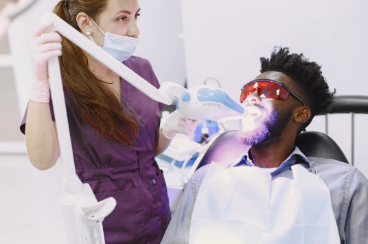 man receiving tooth whitening treatment