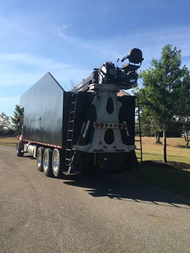 A large black truck is parked on the side of the road.