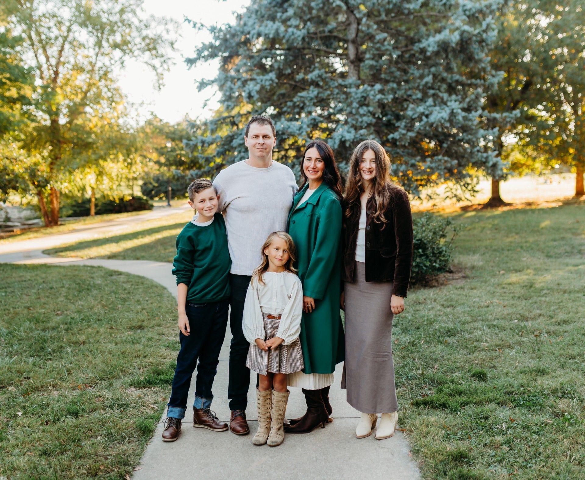 A family is posing for a picture in a field.