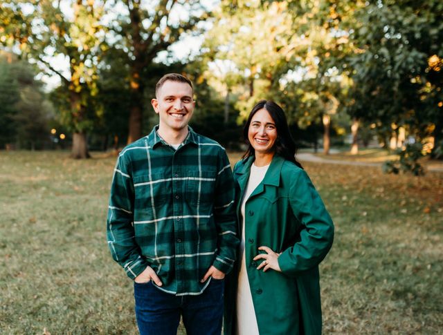 A man and a woman are walking down a sidewalk.