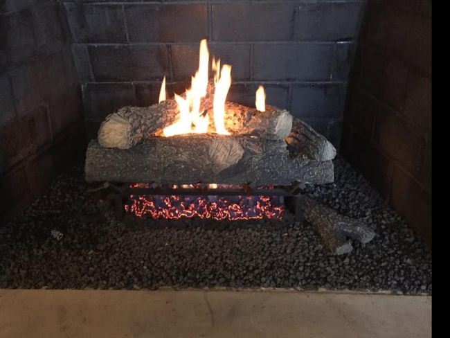 A fireplace with a lot of logs in it