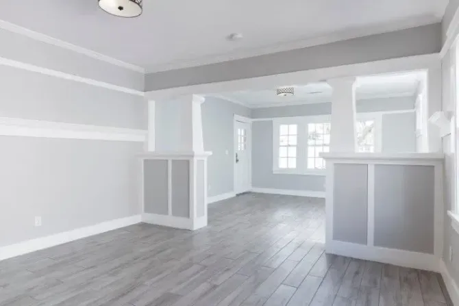 Empty modern living room with fresh grey and white trim paint.
