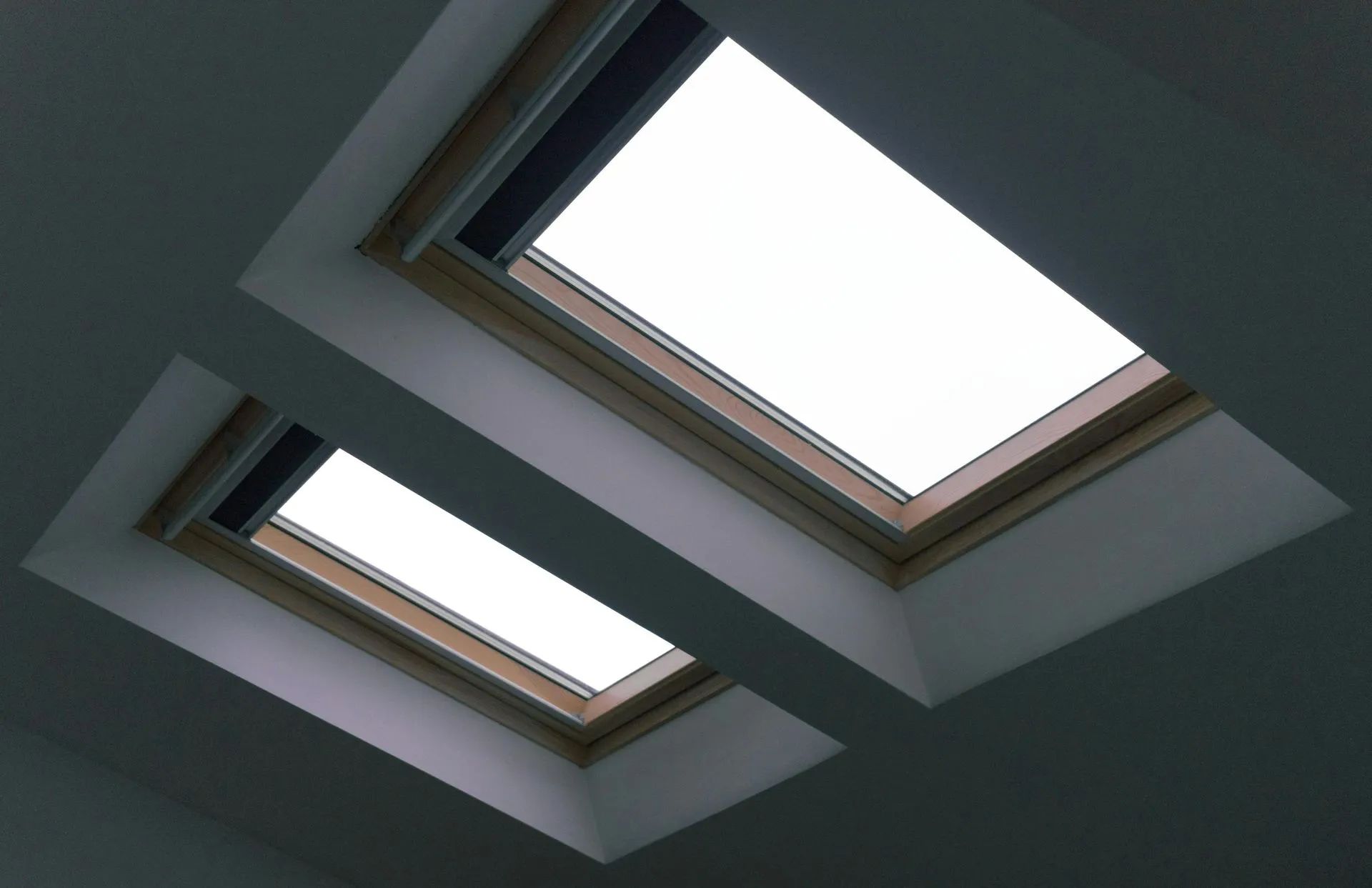 Two rectangular skylights in a white ceiling; bright daylight shines through.