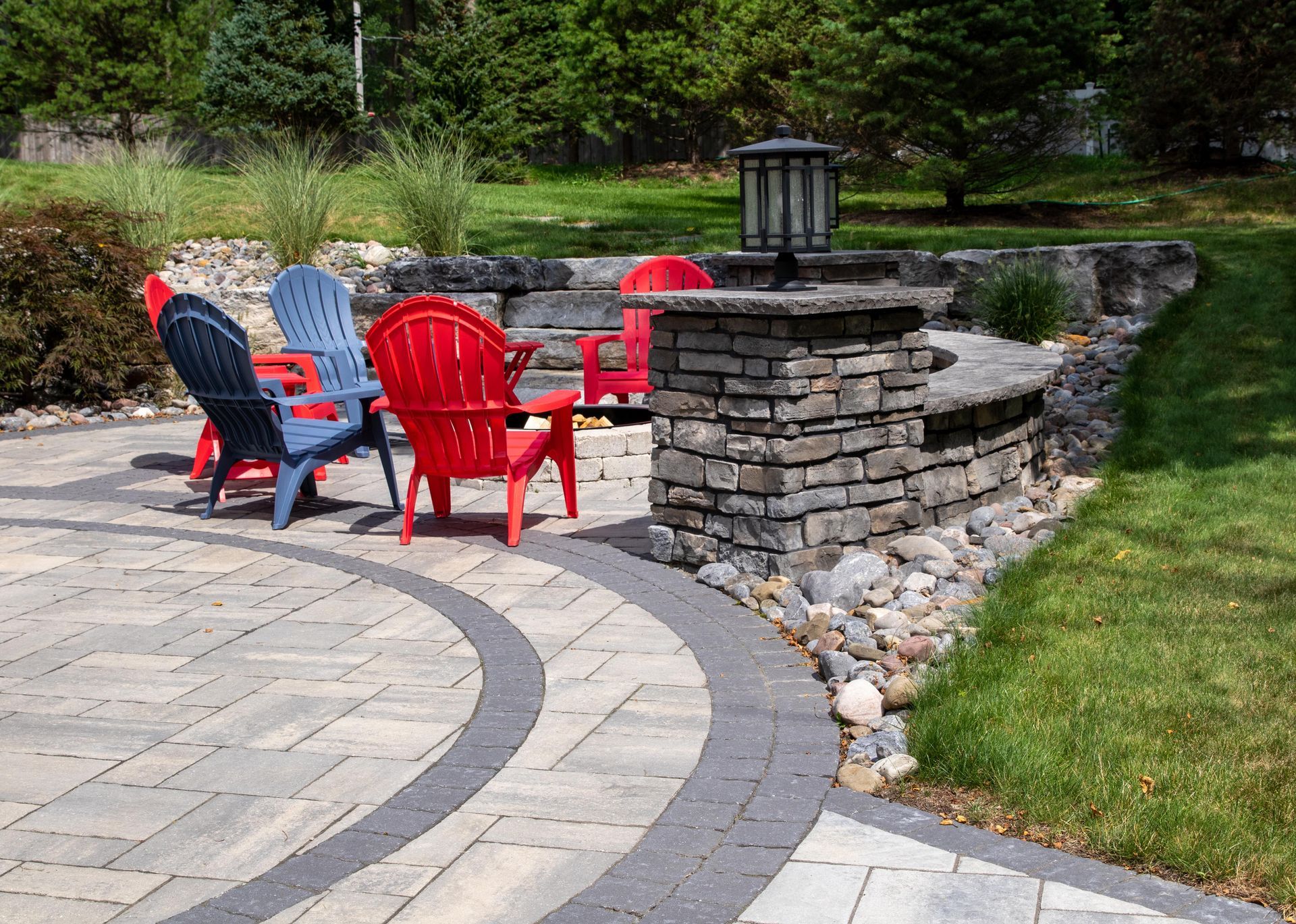 Retaining Wall Design by Hunter Springs Landscape Artisans featuring curved natural stone retaining wall and colorful seating.