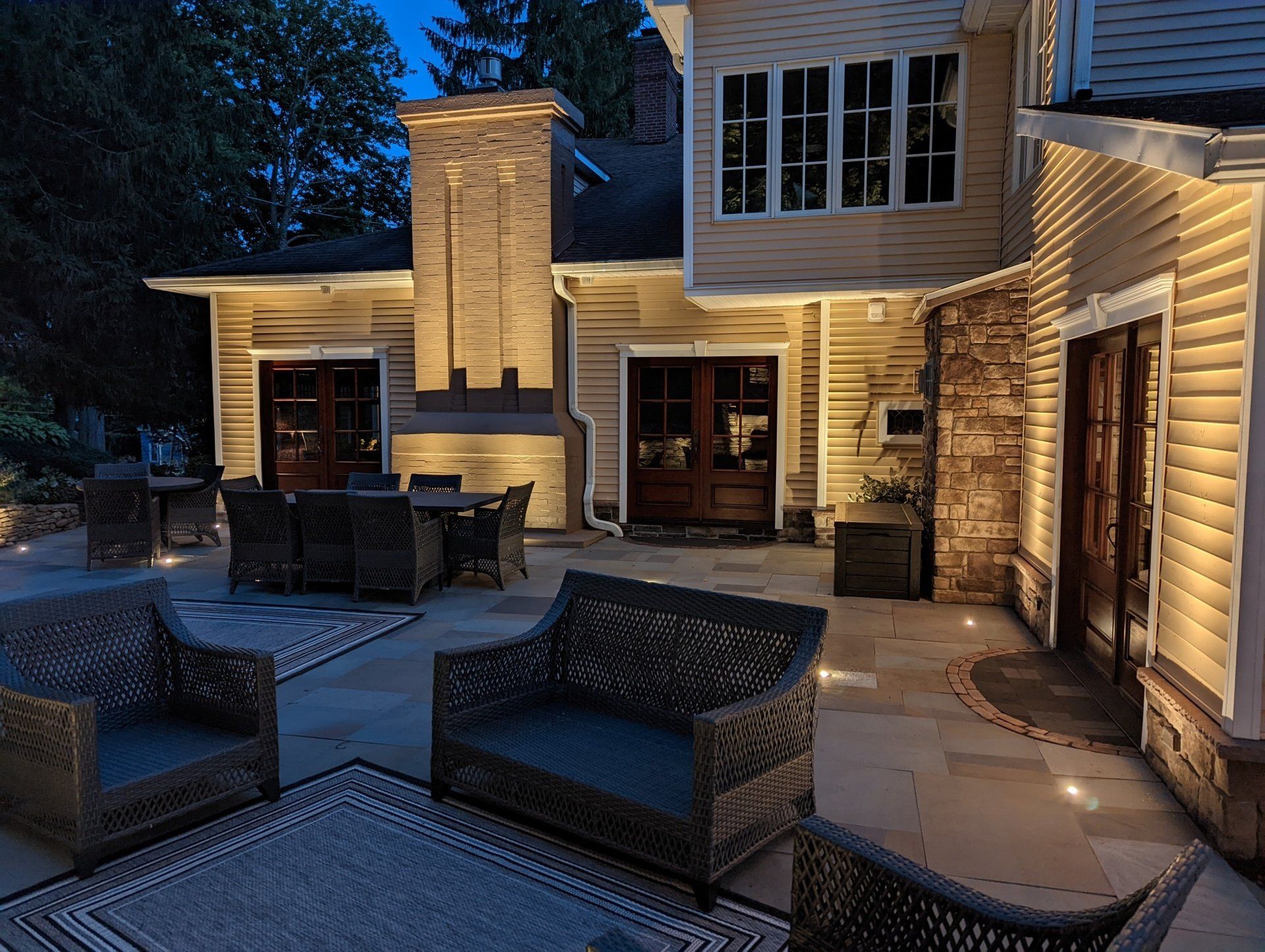 the backyard of a house is lit up at night .