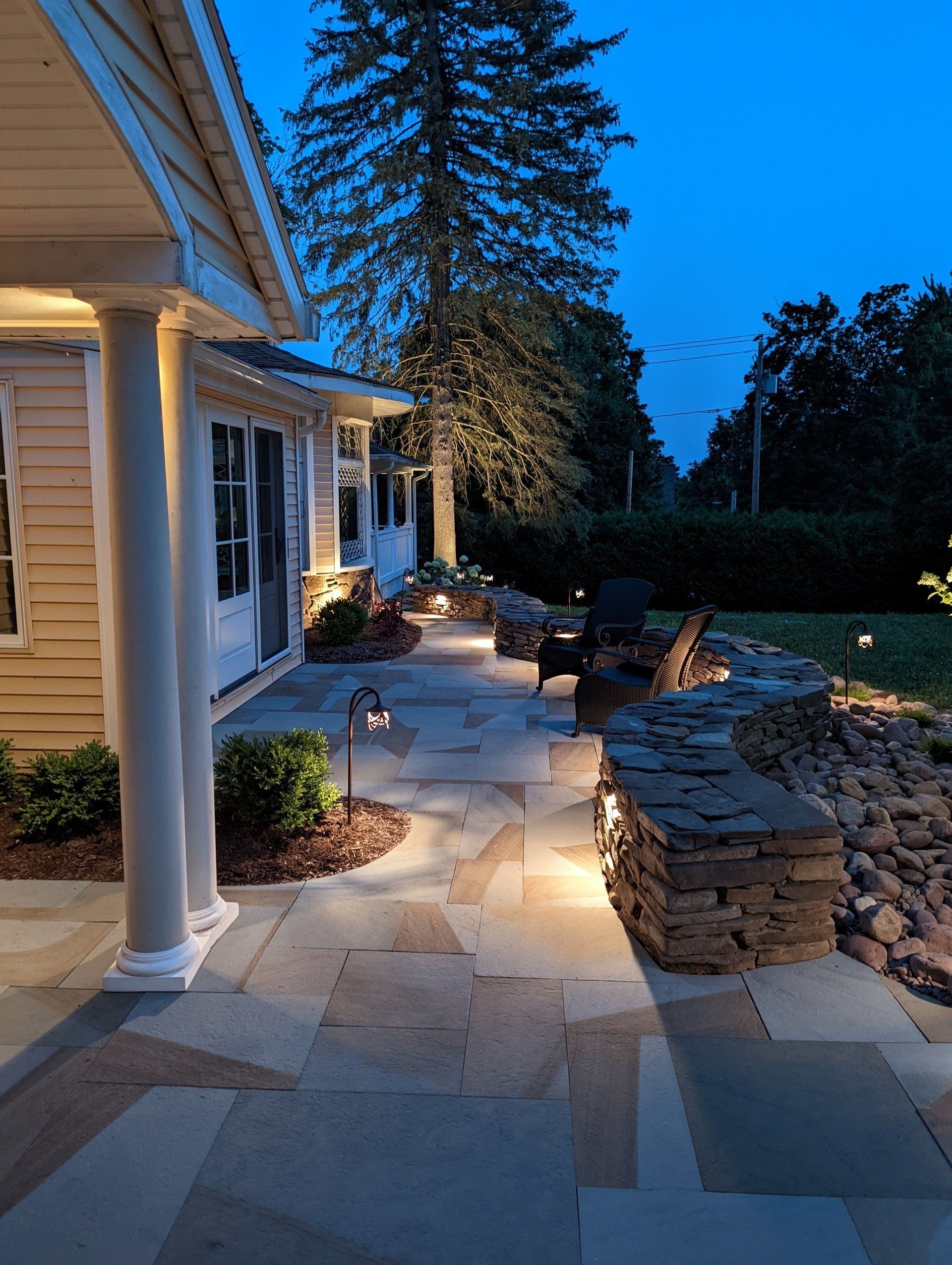 a house with a stone walkway leading to it at night