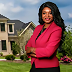Woman in a pink blazer smiling with arms crossed in front of suburban houses and lawn