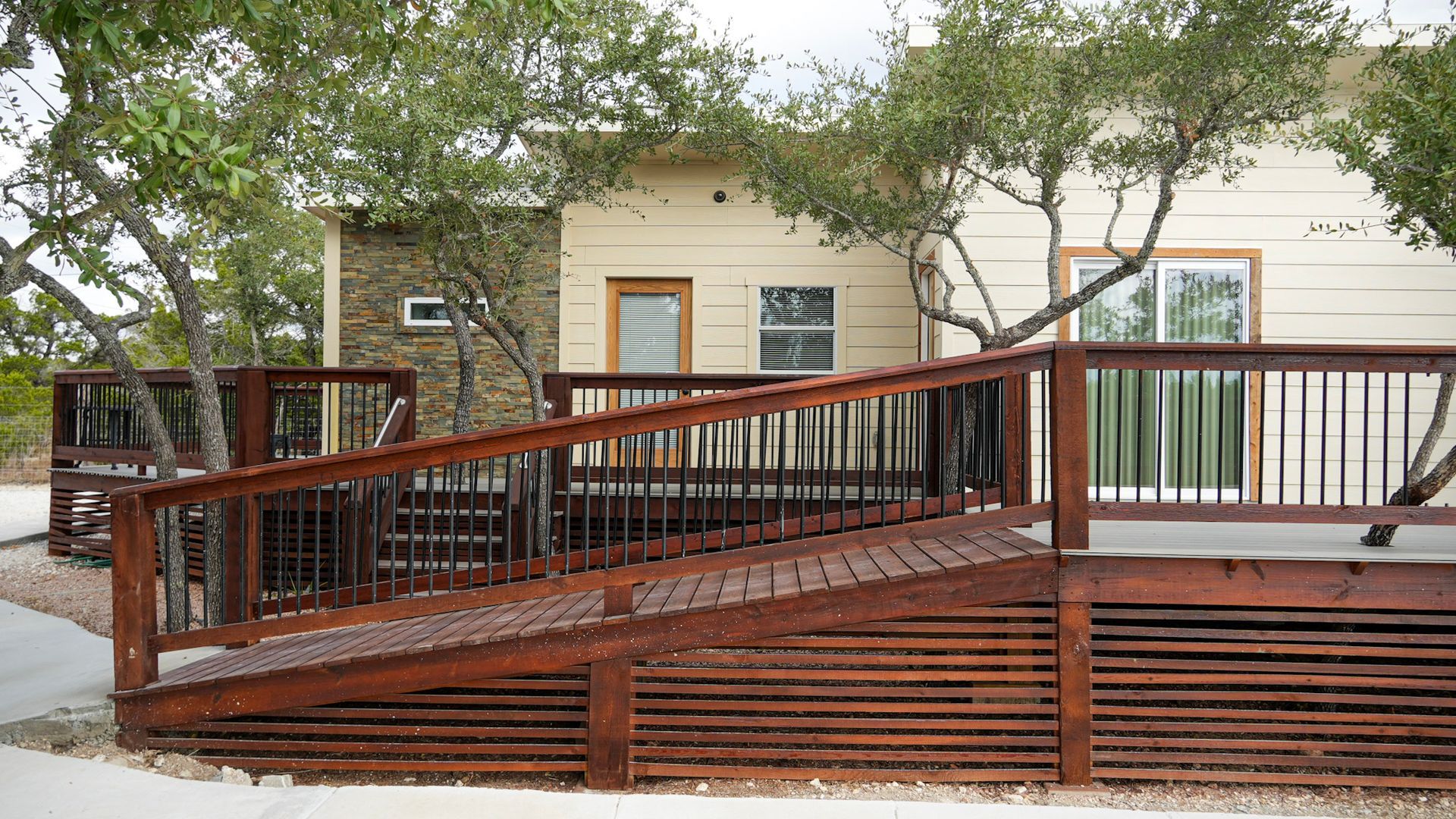 A man and a woman are sitting on a couch holding glasses of orange juice.