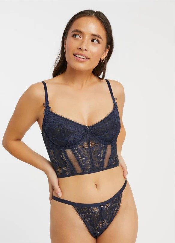 a woman in a black dress is standing in front of a window