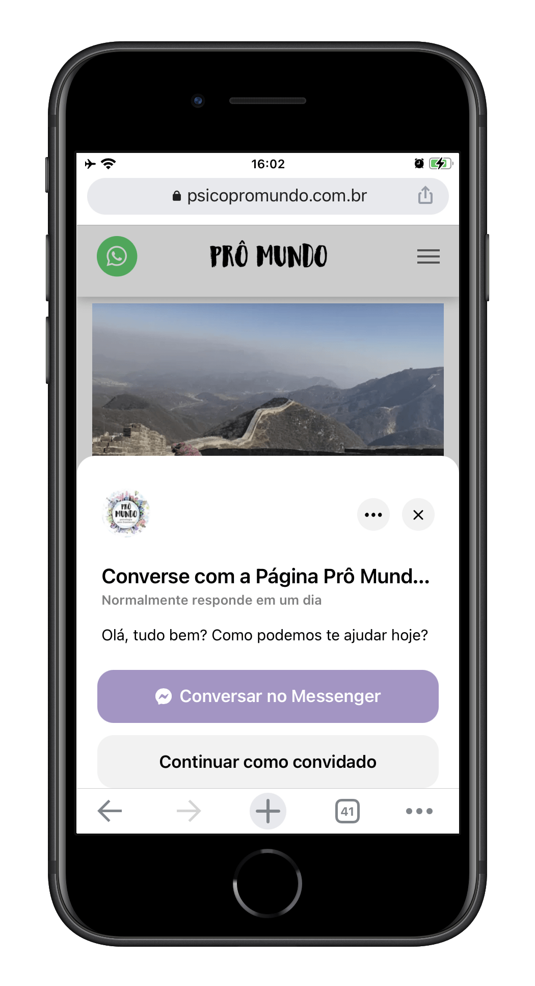 A cell phone with a picture of a mountain on the screen.