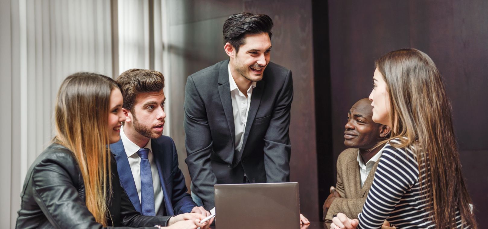 A group of people are having a meeting in a conference room.