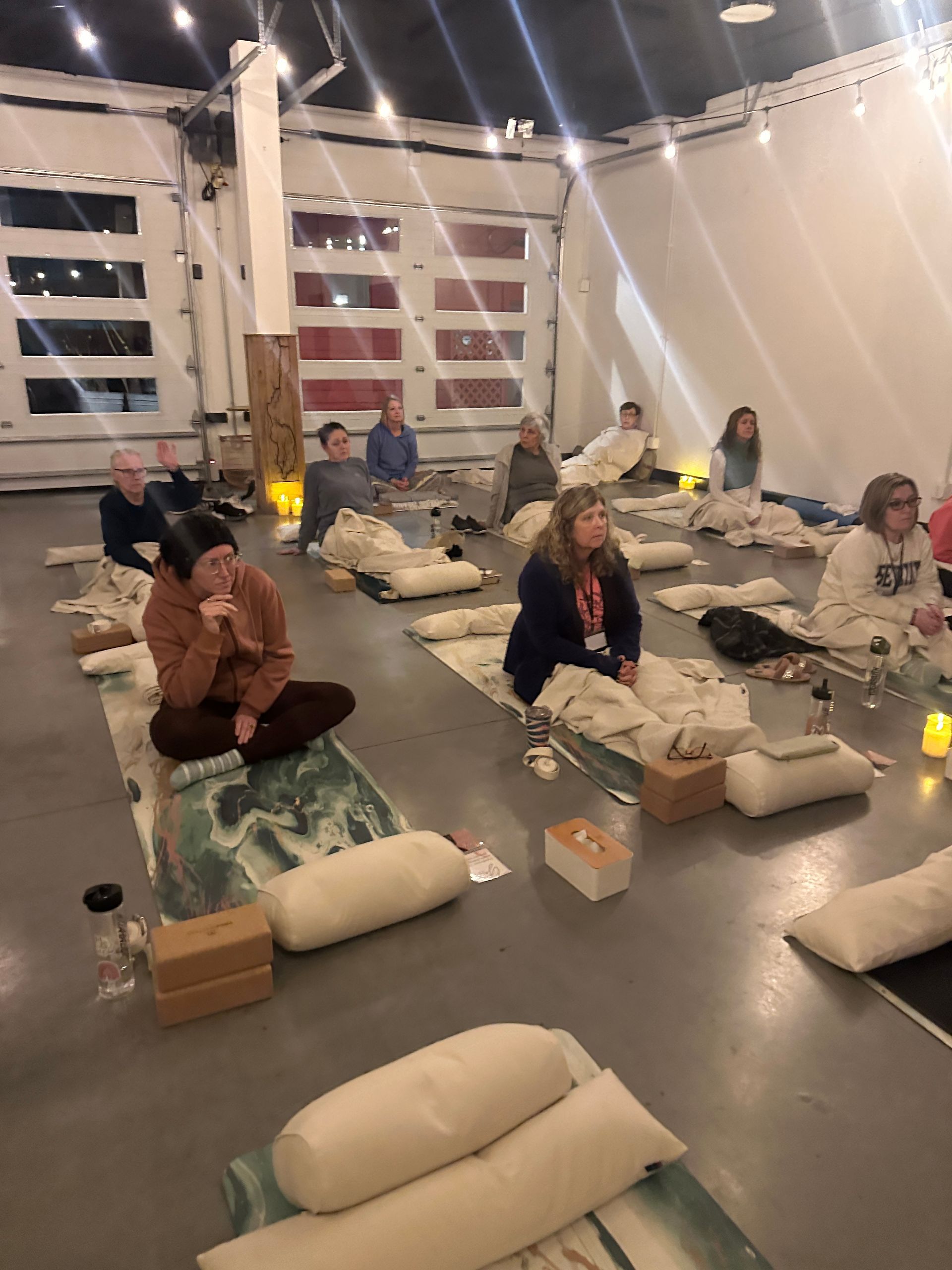 Energetic vinyasa flow yoga class with participants moving through dynamic poses
