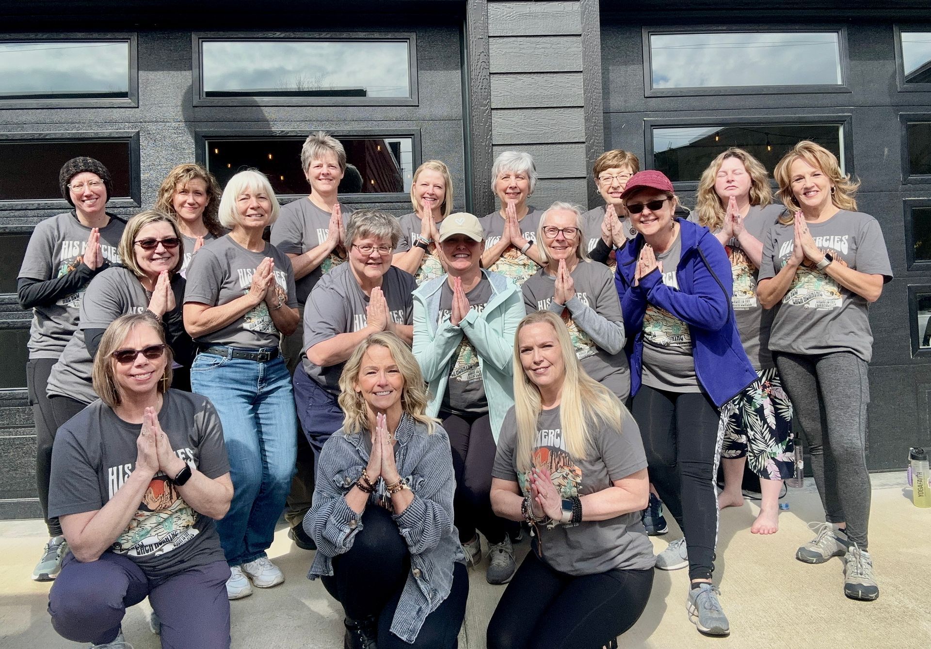 Joyful yogis sharing positive energy during a community yoga event