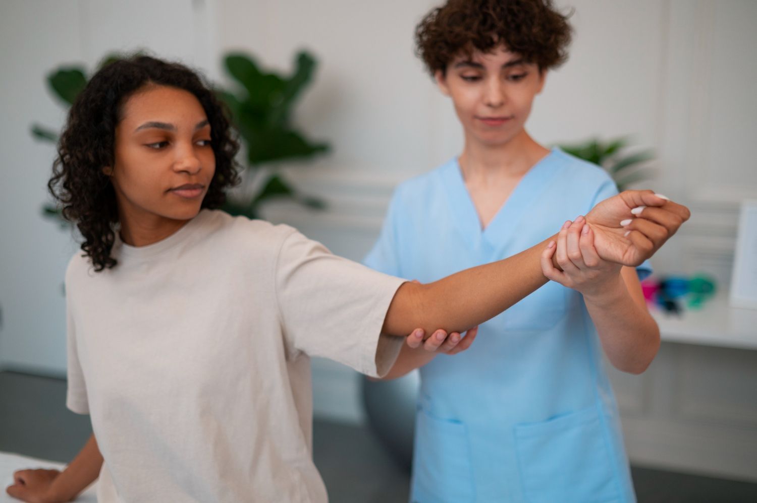 A nurse is examining a patient 's arm in a hospital.