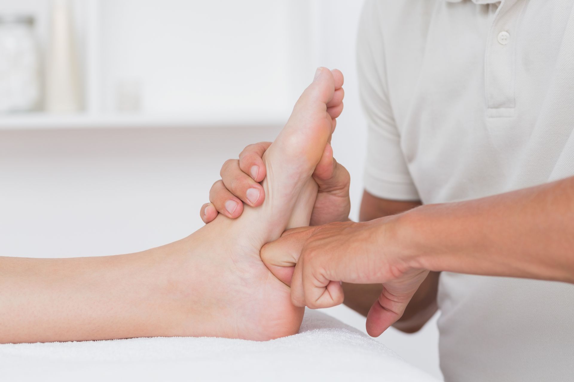 A person is getting a foot massage from a doctor.