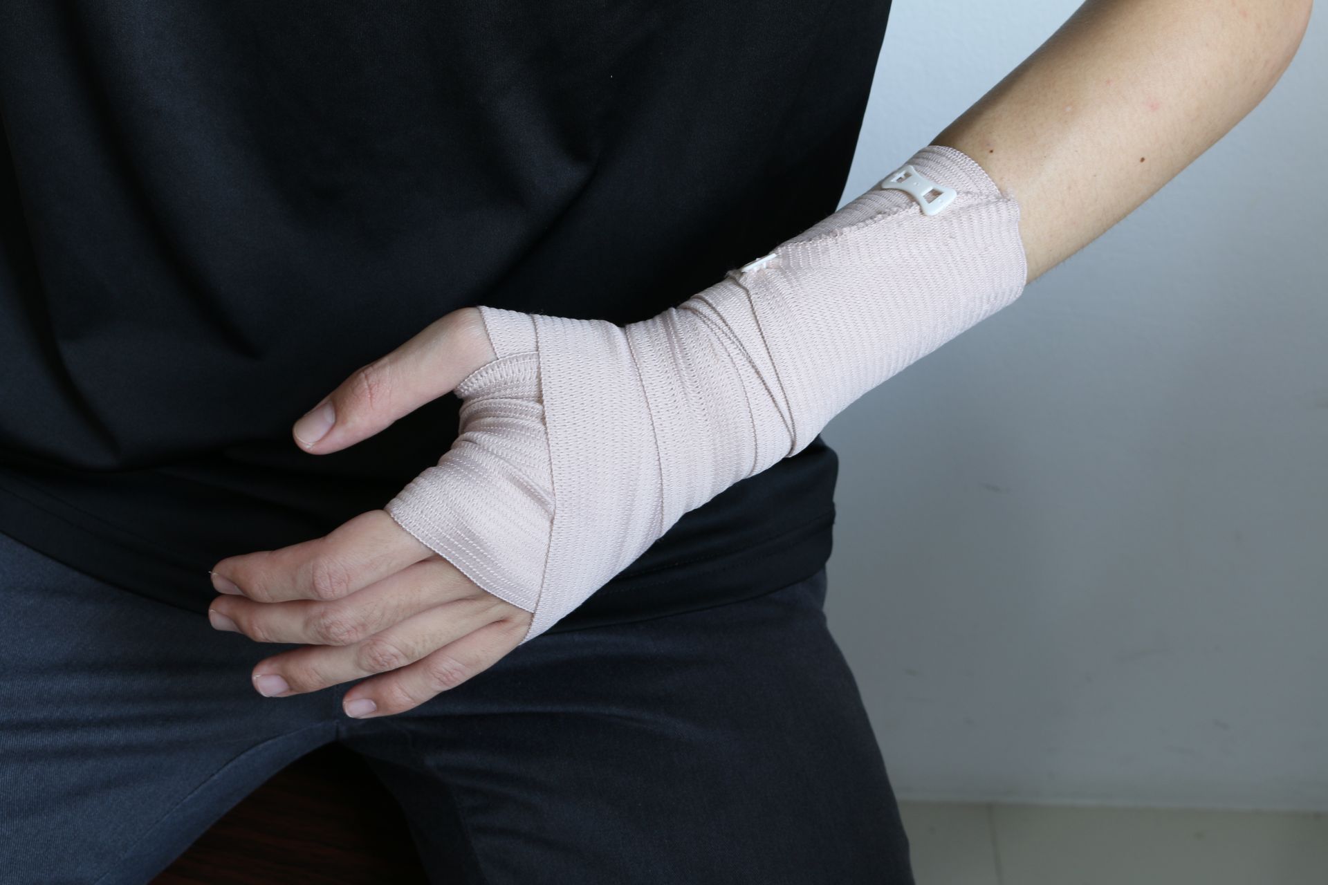 A person with a bandage on their wrist