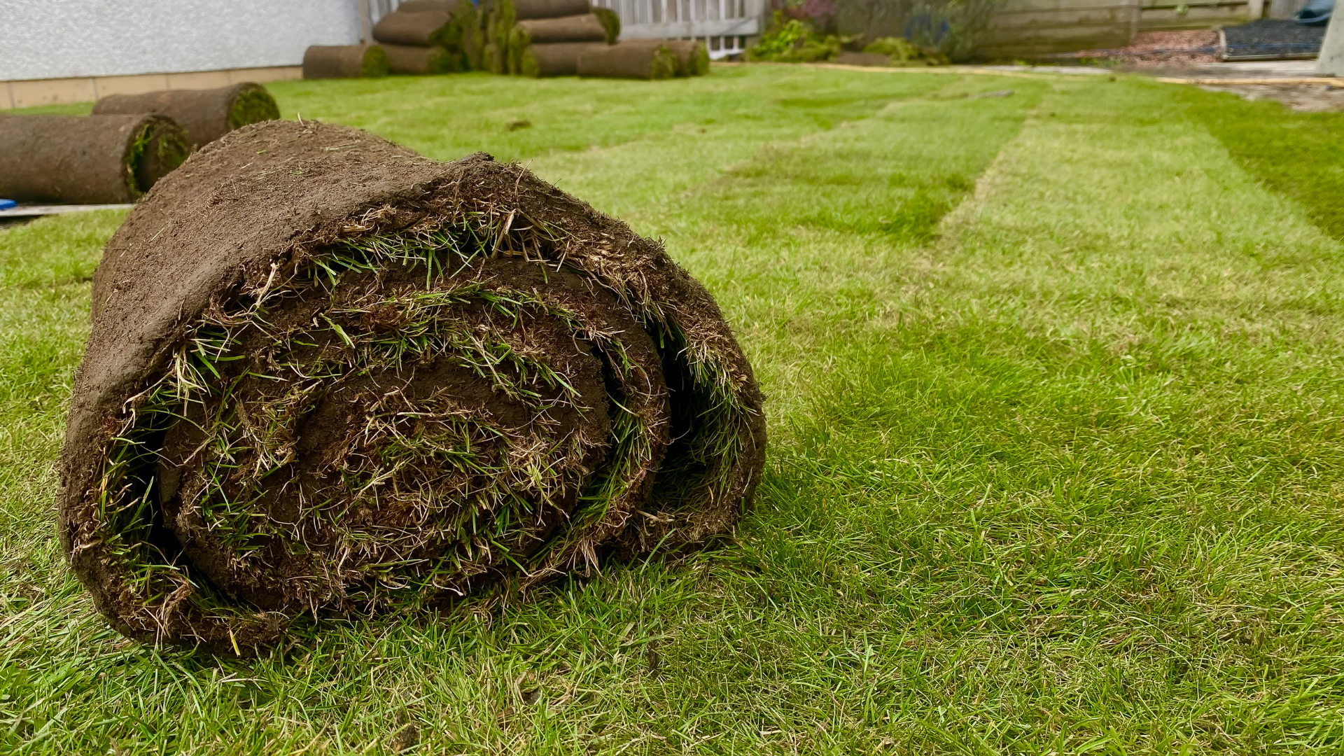 Power washer cleaning a weathered wooden fence.