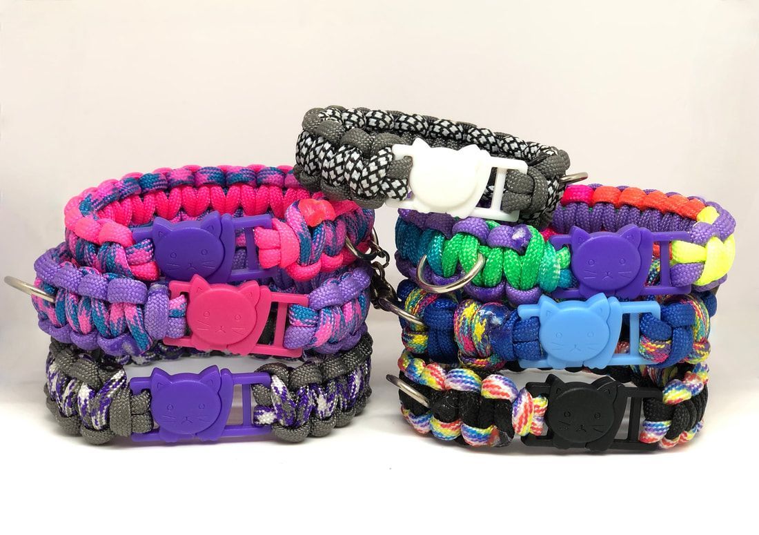 A bunch of bracelets are stacked on top of each other on a table.