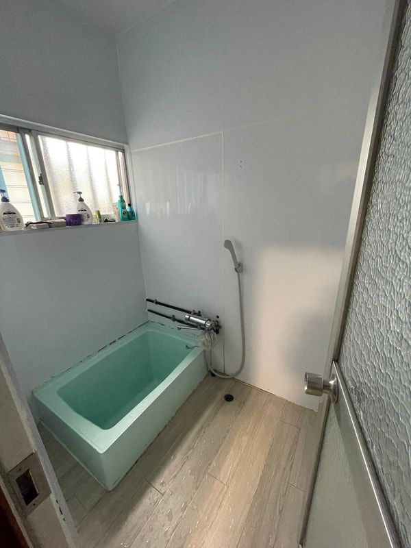 A bathroom with a bathtub and a shower.
