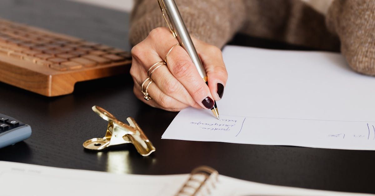 Image of a hand on paper writing an estate plan