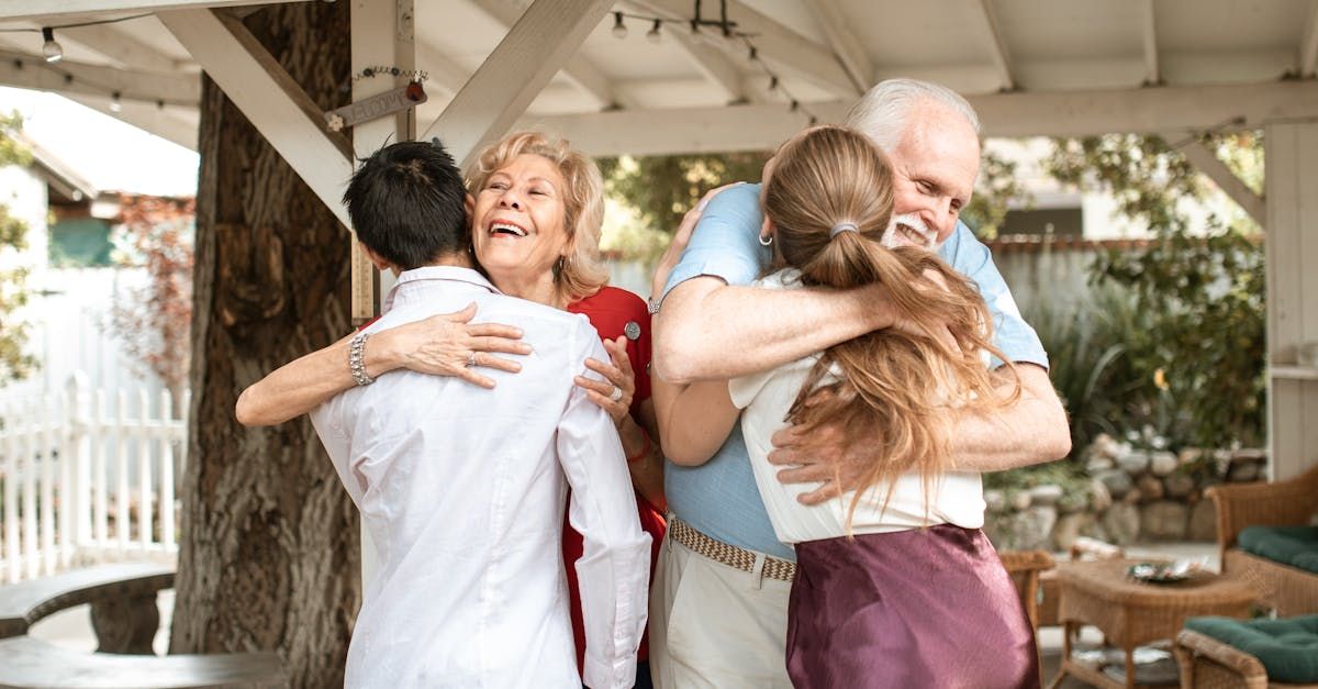 Image of two older parents hugging their adult children