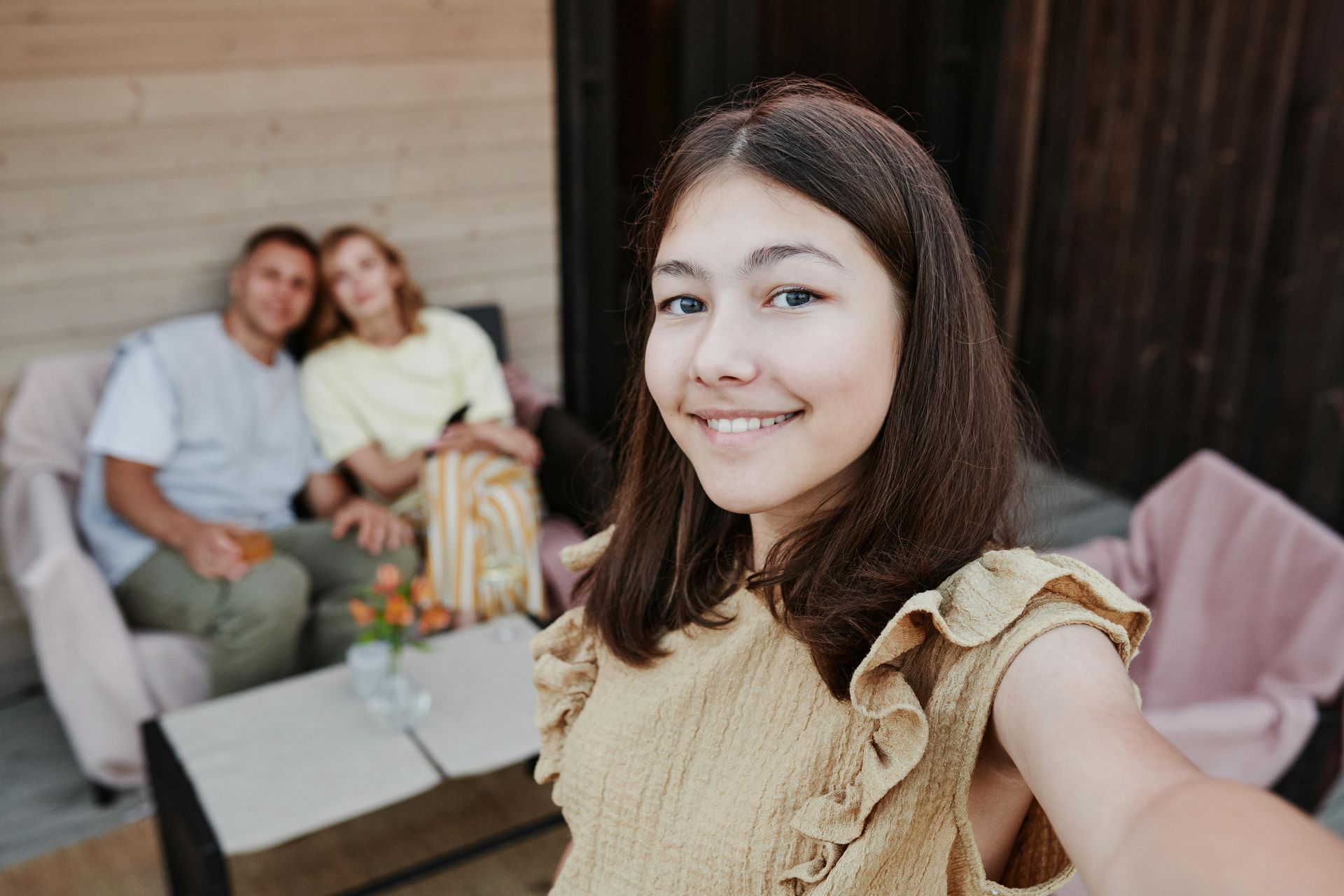 image of teen taking a selfie with parents