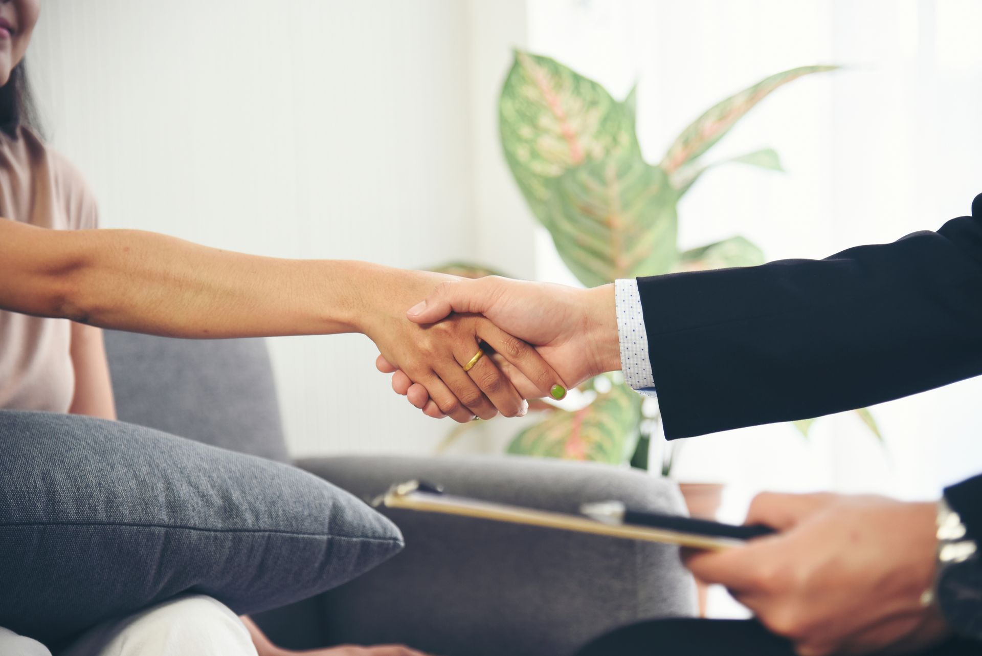 Two people shaking hands- Click to read blog post about revocable and irrevocable trusts