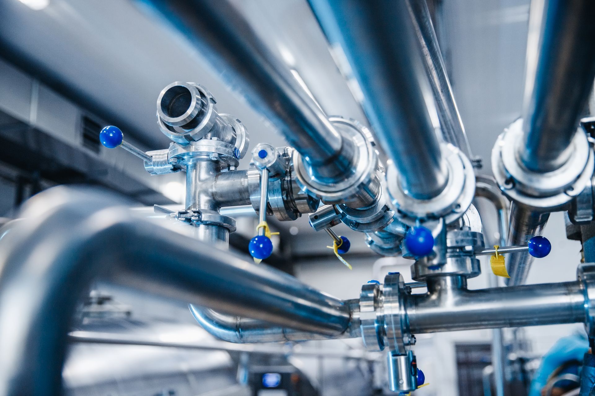 A close up of stainless steel pipes in a factory.