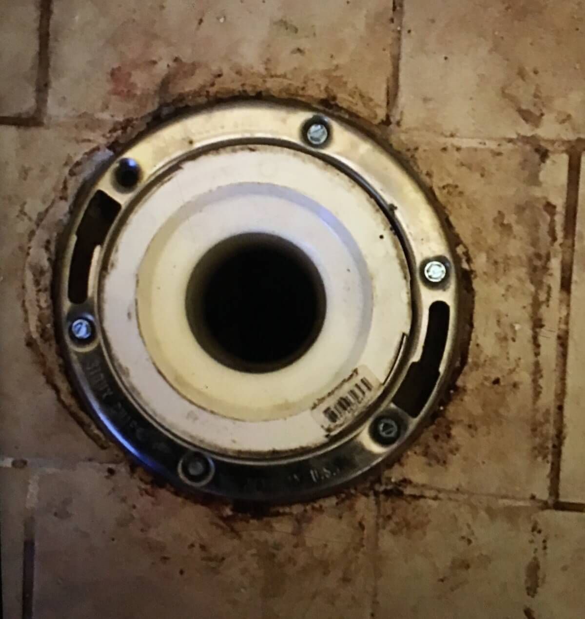 A close up of a hole in a brick wall