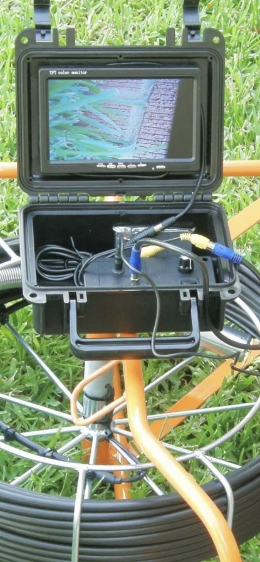 A hose with a camera attached to it is sitting on top of a wheel.