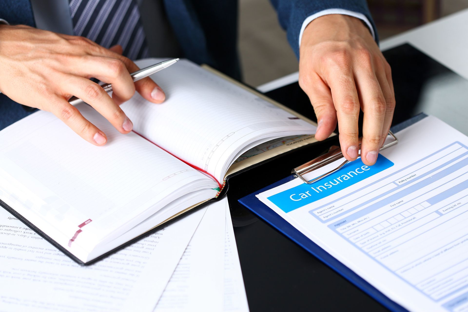An insurance agent providing guidance to a client on minimizing their car insurance costs.