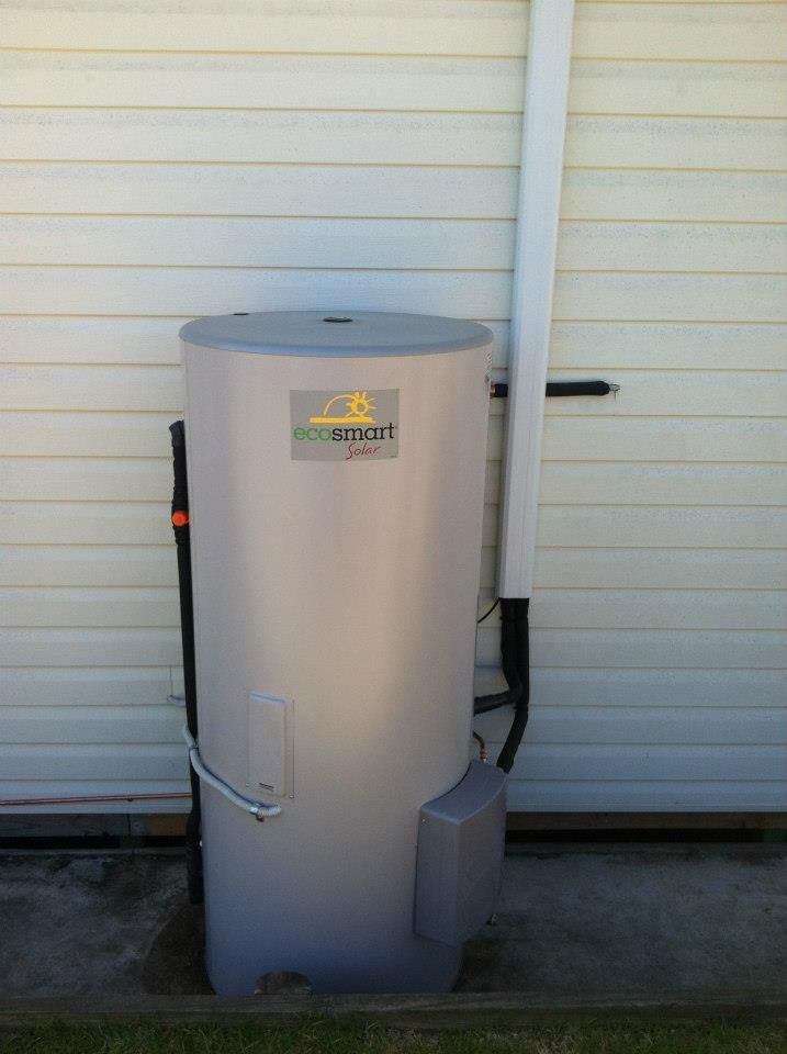 A Large White Water Heater is Sitting on the Side of a Building — Sapphire City Solar & Electrical In Narrabri, NSW